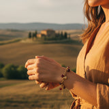 BRACCIALE CON PIETRE ROSSE E CIONDOLO A CUORE DORATO